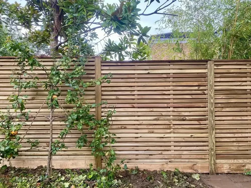 A completed panel fence in a Kent garden, built on site by Fencecraft
