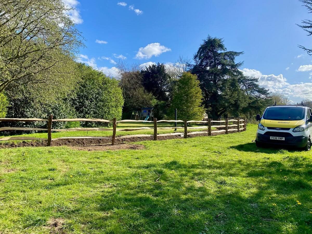 New post and rail fencing enclosing a garden paddock in Kent