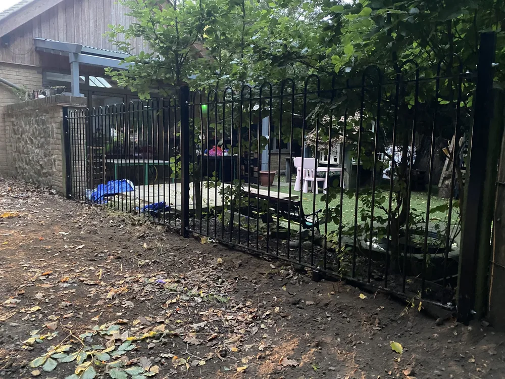 Bow-top railings and a gate securing a nursery outdoor play area